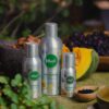 Organic hair growth oil bottles displayed with natural ingredients like seeds and nuts.
